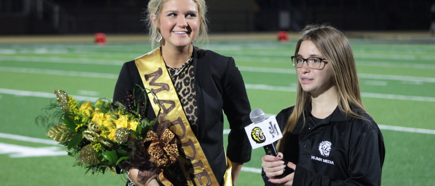 STUDENT INTERVIEWING HOMECOMING QUEEN