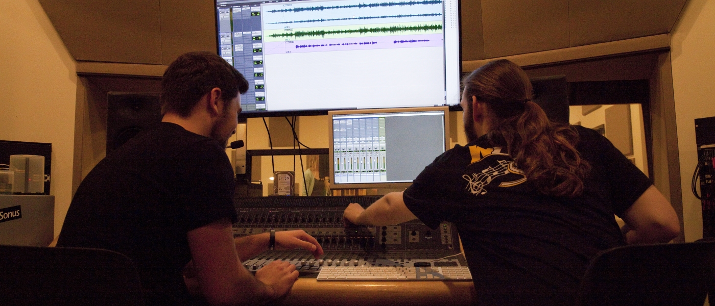 Music students working in recording studio